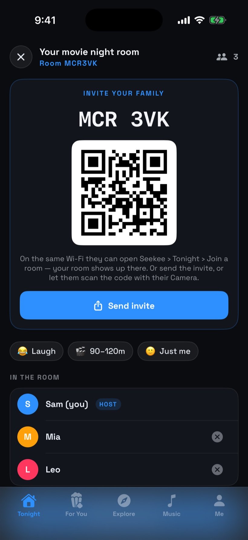 A movie night room with its invite QR code and three people in the room